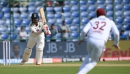 India's KL Rahul (L) reacts after playing a shot during the first day of the second and last Test cricket match between India and West Indies at the Arun Jaitley Stadium in New Delhi on October 10, 2025. (Photo by Sajjad Hussain / AFP)