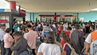 People gather outside a mall in Butuan City, on the southern island of Mindanao on October 10, 2025, after a 7.4-magnitude earthquake struck off the southern Philippines. (Photo by Erwin MASCARINAS / AFP)