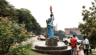 Vehicles pass in front of the statue of a lady holding a torch, in front of the party headquarters of the Cameroon People's Democratic Movement of incumbent Cameroonian President Paul Biya, in Yaounde, on October 10, 2025. (Photo by Daniel Beloumou Olomo / AFP)