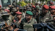 Members of a Madagascar army contingent talk to the media in a road near their camp near Antananarivo on October 11, 2025. (Photo by RIJASOLO / AFP)

