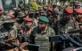 Members of a Madagascar army contingent talk to the media in a road near their camp near Antananarivo on October 11, 2025. (Photo by RIJASOLO / AFP)
