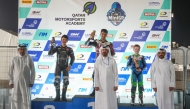 Champion Jake Franklin (top centre), Mohammed Adel Al Mutawa and Anas Boukabache pose for a photo with officials during the presentation ceremony.