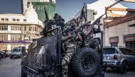 Members of Madagascar’s Army CAPSAT unit ride in armoured vehicles while assuming a defensive posture as they leave the Presidential Palace in Antananarivo, October 14, 2025. (Photo by Luis Tato / AFP)