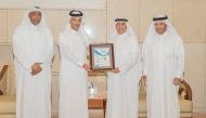 UDST President Dr. Salem Al-Naemi receiving the certificate at a ceremony.