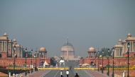 People walk past Kartavya Path near India's presidential palace (Rashtrapati Bhavan) in New Delhi on October 14, 2025. (Photo by Arun Sankar / AFP)