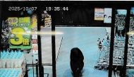 This handout photo taken on October 7, 2025 and released by Gunma Prefectural Police via Jiji Press shows CCTV camera footage of a bear walking inside a supermarket in Numata, Gunma prefecture. Photo by Handout / various sources / AFP
