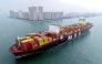 (Files) This aerial view shows a container ship moving towards its berth at the container terminal of the port in Qingdao, in China's eastern Shandong province, on September 24, 2025. (Photo by AFP) 