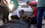 Friends and relatives mourn over the shrouded body of a man killed in an Israeli strike earlier, as he is brought to Deir al-Balah's Shuhada al-Aqsa hospital in the central Gaza Strip on October 19, 2025. (Photo by BASHAR TALEB / AFP)

