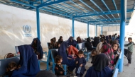 Afghan women and children refugees deported from Pakistan wait inside a registration centre upon their arrival at the zero point border crossing between Afghanistan and Pakistan in the Spin Boldak district of Kandahar province on October 19, 2025. (Photo by Sanaullah Seiam / AFP)
