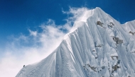 In this handout photograph taken on October 15, 2025, a French mountaineer makes his way near the summit of Jannu East, the first ascent of the 7,468 m peak in eastern Nepal. (Photo by Thibaut Marot / AFP)