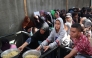 Palestinian children gather to receive food portions from a charity kitchen in the Nuseirat refugee camp, located in the central Gaza Strip, on October 21, 2025. (Photo by Eyad Baba / AFP)