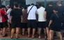 This undated handout from Agence Kampuchea Press (AKP) released on October 23, 2025 shows people, suspected of being involved in online scams, gathering during a raid on a scam centre in Phnom Penh. (Photo by Handout / Agence Kampuchea Press (AKP) / AFP)