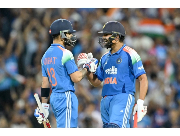 India's Rohit Sharma (R) and Virat Kohli celebrate their win at the Sydney Cricket Ground in Sydney on October 25, 2025. (Photo by Saeed Khan / AFP) 