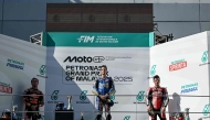 BK8 Gresini Racing MotoGP team's Spanish MotoGP rider Alex Marquez (C) celebrates on the podium after winning the MotoGP Malaysian Grand Prix with second-placed Red Bull KTM Factory Racing team's Spanish MotoGP rider Pedro Acosta (L) and third-placed Honda HRC Castrol team's Spanish MotoGP rider Joan Mir (R) at the Sepang International Circuit in Sepang on October 26, 2025. (Photo by Lillian SUWANRUMPHA / AFP)