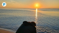 A man captures the rising sun over Sealine in Mesaieed, as morning temperatures cool across Qatar. Photo by Marivie Alabanza / The Peninsula