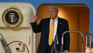 US President Donald Trump gestures as he prepares to alight from Air Force One upon arrival at Haneda Airport in Tokyo on October 27, 2025. (Photo by Philip Fong / AFP)
 