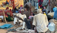 Displaced Sudanese who fled El-Fasher after the city fell to the Rapid Support Forces (RSF), rest near the town of Tawila in war-torn Sudan's western Darfur region on October 28, 2025. Photo by STR / AFP.