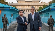 This handout photo taken on November 3, 2025 and provided by the South Korean Defence Ministry shows US Defense Secretary Pete Hegseth (R) shaking hands with South Korean Defence Minister Ahn Gyu-back (L) as they visit the truce village of Panmunjom in the Demilitarized Zone (DMZ) dividing the two Koreas. Photo by Handout / South Korean Defence Ministry / AFP