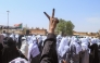 A Sudanese Student flashes the V-sign for victory as schools in the East Nile region of the capital gather during a protest against violations committed by the Rapid Support Forces (RSF) against the people of El- Fasher, in Khartoum on November 3, 2025. (Photo by Ebrahim Hamid / AFP)
