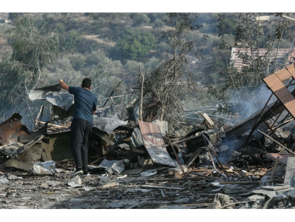 A man stands amid the debris at the site of an Israeli airstrike in the southern Lebanese village of Toura on November 6, 2025. (Photo by MAHMOUD ZAYYAT / AFP)