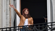 Argentina's former President (2007-2015) and vice-president (2019-2023) Cristina Fernandez de Kirchner waves at supporters from the balcony of her residence where she is serving house arrest in Buenos Aires. Photo by Luis Robayo / AFP
