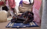A displaced Sudanese who fled El-Fasher after the city fell to the Rapid Support Forces (RSF), rest on a mat in the camp of Um Yanqur, located on the southwestern edge of Tawila, in war-torn Sudan's western Darfur region on November 3, 2025. (Photo by AFP)
