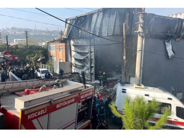 Rescuers and firefighters working at the site of a perfume warehouse where a fire broke out in the Dilovasi district of Kocaeli. Photo by Handout / DHA-Demiroren News Agency / AFP