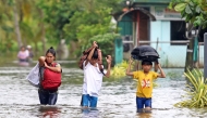 Residents evacuate from their flooded homes due to heavy rain brought by Typhoon Fung-wong in Remedios T. Romualdez. Photo by Erwin Mascarinas/ AFP
