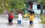 Residents evacuate from their flooded homes due to heavy rain brought by Typhoon Fung-wong in Remedios T. Romualdez. Photo by Erwin Mascarinas/ AFP