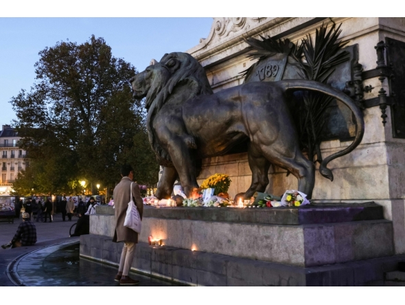 A man stands in front of a makeshift memorial in tribute of the victims of Paris' attacks of November 13, 2015, at the place de la Republique, in Paris, on November 8, 2025. (Photo by Geoffroy Van Der Hasselt / AFP)