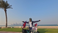 Nepali cyclist Niranjan Aryal with his cycle at Doha Corniche.