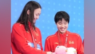Li Bingjie (L) and Yu Zidi  react during the awarding ceremony for the women's 4X100m freestyle relay of swimming event at China's 15th National Games in Shenzhen, south China's Guangdong Province, Nov. 10, 2025.  Photo: Xinhua/Du Yu