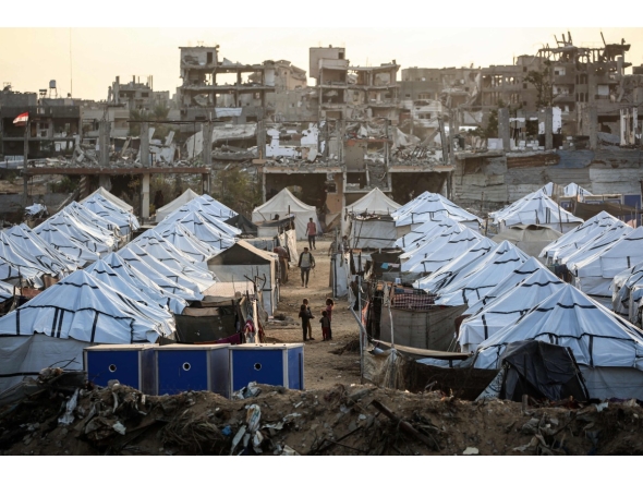 Young Palestinian girls play in a new displacement camp set up by the Egyptian Committee in Nuseirat, Gaza Strip on November 11, 2025. (Photo by Eyad Baba / AFP)