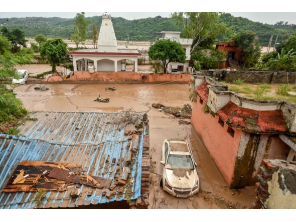 File photo: A damaged car is pictured under mud and debris after heavy rains induced flood in Jammu on August 27, 2025. Photo by AFP