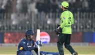Sri Lanka's Maheesh Theekshana (L) reacts at at the end of the first one-day international (ODI) cricket match between Pakistan and Sri Lanka at the Rawalpindi Cricket Stadium in Rawalpindi on November 11, 2025. (Photo by Aamir QURESHI / AFP)