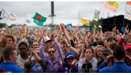 Festival goers attend concerts at the Pyramid Stage during the third day of the Glastonbury Festival of Contemporary Performing Arts near Glastonbury, southwest England, on June 28, 2013. Photo by ANDREW COWIE / AFP