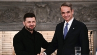 Greece's Prime Minister Kyriakos Mitsotakis (R) and Ukraine's President Volodymyr Zelensky shake hands after attending a joint press conference following their meeting in Athens, on November 16, 2025. Photo by Angelos Tzortzinis / AFP