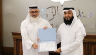 Director of the Zakat Affairs Department MalAllah Abdulrahman Al Jaber (right) honouring a company representative.