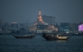 Tourists ride traditional boats along the corniche promenade in Doha on November 12, 2025. Photo by Mahmud HAMS / AFP