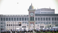 Camel-mounted royal guards patrol around the Amiri Diwan in Doha on November 13, 2025. (Photo by MAHMUD HAMS / AFP)