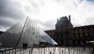 Tourists queue to enter the Louvre museum next to the Louvre pyramid designed by Chinese-US architect Ieoh Ming Pei, in Paris, on November 3, 2025. A gallery in the Louvre was closed to the public due to the building's 