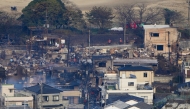 Smouldering buildings are seen following an overnight fire at a residential area near the Saganoseki Fishing Port in Oita City on November 19, 2025.  (Photo by Jiji Press / AFP)