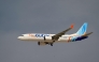 A Flydubai Boeing 737 MAX 8 performs a display flight at Al-Maktoum International Airport during the Dubai Airshow 2025 in Dubai on November 17, 2025. (Photo by Giuseppe CACACE / AFP)