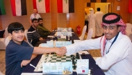 Qatar's Hamad Al Kuwari (right) shakes hand with Kuwait's Hussein Suleiman before the start of their second round match.