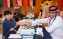 Qatar's Hamad Al Kuwari (right) shakes hand with Kuwait's Hussein Suleiman before the start of their second round match.