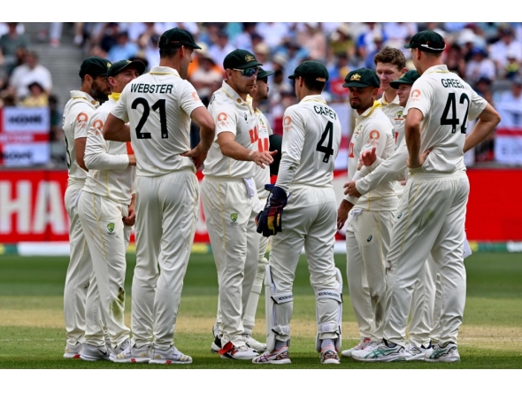 Australian players wait for the third umpire decision on England's Jamie Smith dismissal on day 2 of the first Ashes cricket Test match between Australia and England at Perth Stadium in Perth on November 22, 2025. (Photo by Saeed Khan / AFP) /