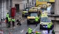 Police officers investigate the scene of an incident in Water Street, on the sidelines of an open-top bus victory parade for Liverpool's Premier League title win, in Liverpool, north-west England on May 26, 2025. (Photo by Darren Staples / AFP)

