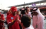 Ferrari's British driver Lewis Hamilton is greeted by a fan.