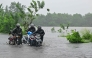 Motorists wade through a flooded street in Biyagama on the outskirts of Colombo on November 28, 2025. (Photo by Ishara S. KODIKARA / AFP)