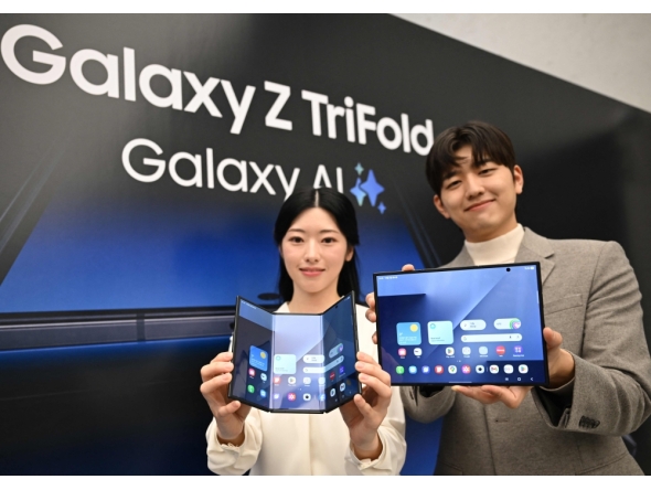 Promoters show Samsung Galaxy Z TriFold smartphones during a launch event at a Samsung store in Seoul on December 2, 2025. (Photo by Jung Yeon-je / AFP)